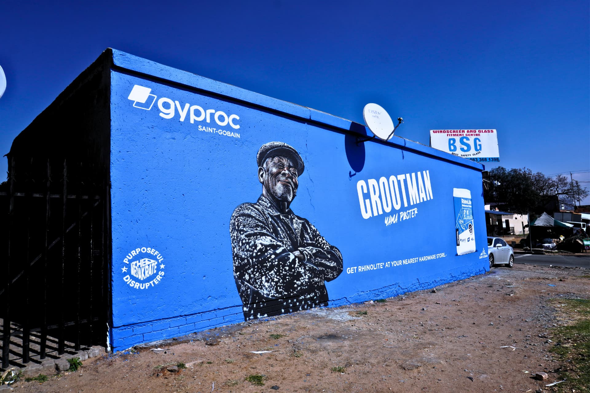Gyproc Saint-Gobain portrait mural on a township wall