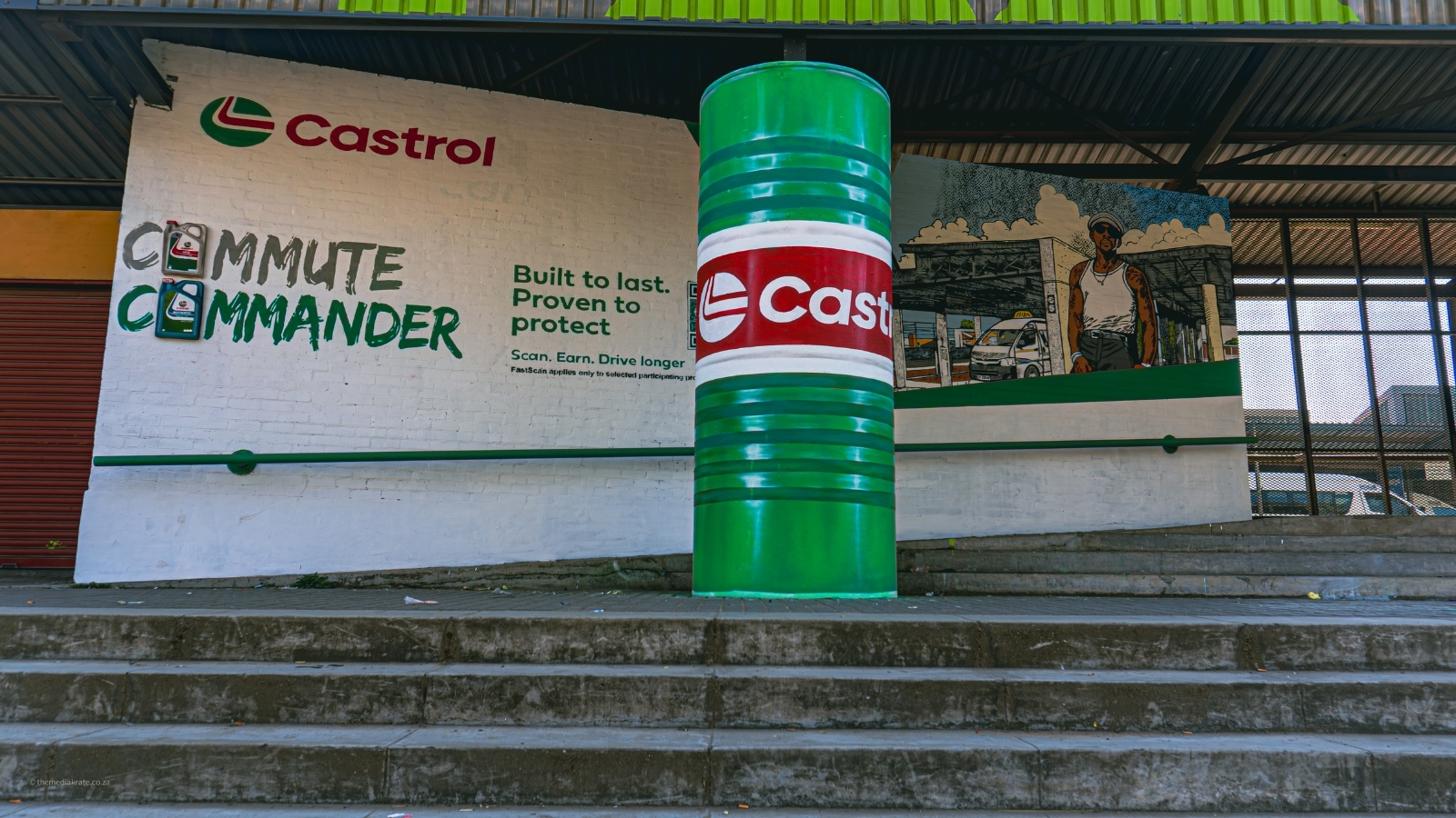 Large Castrol oil drum installation in front of a mural