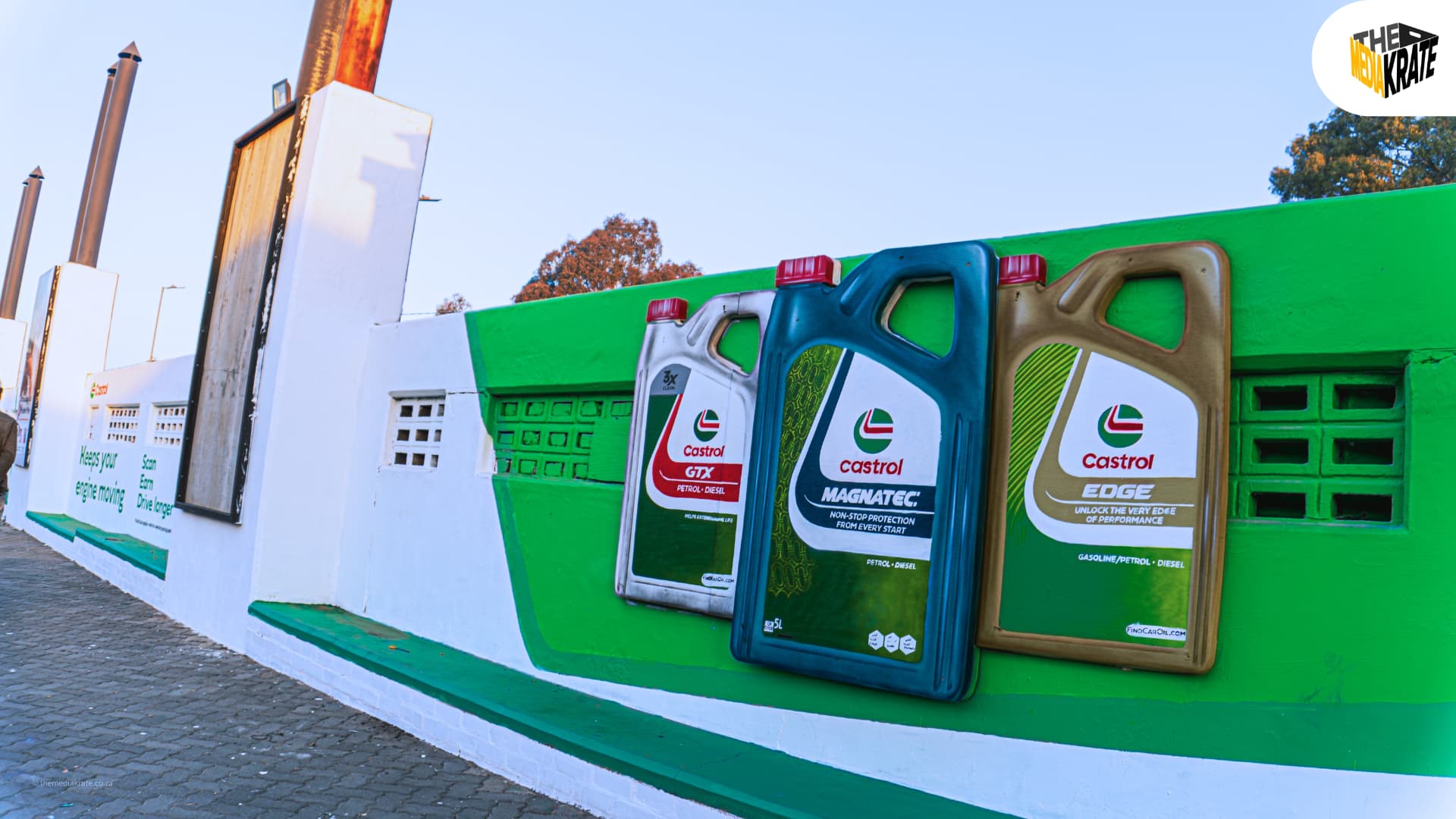3D Castrol oil containers mounted on a green wall